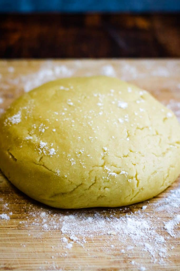 olive oil pie dough in a ball dusted with flour