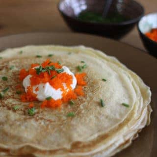 Blini style crepes with sour cream, caviar, and chives