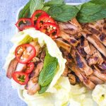 spicy korean gochujang chicken wrapped in crisp lettuce leaf with fresh mint and chiles