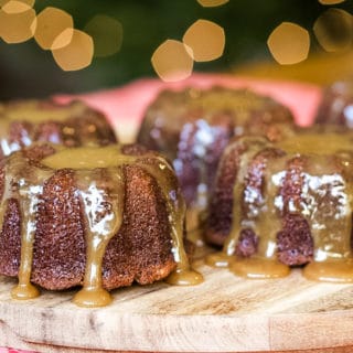 sticky toffee pudding cakes on a board drizzled with toffee sauce