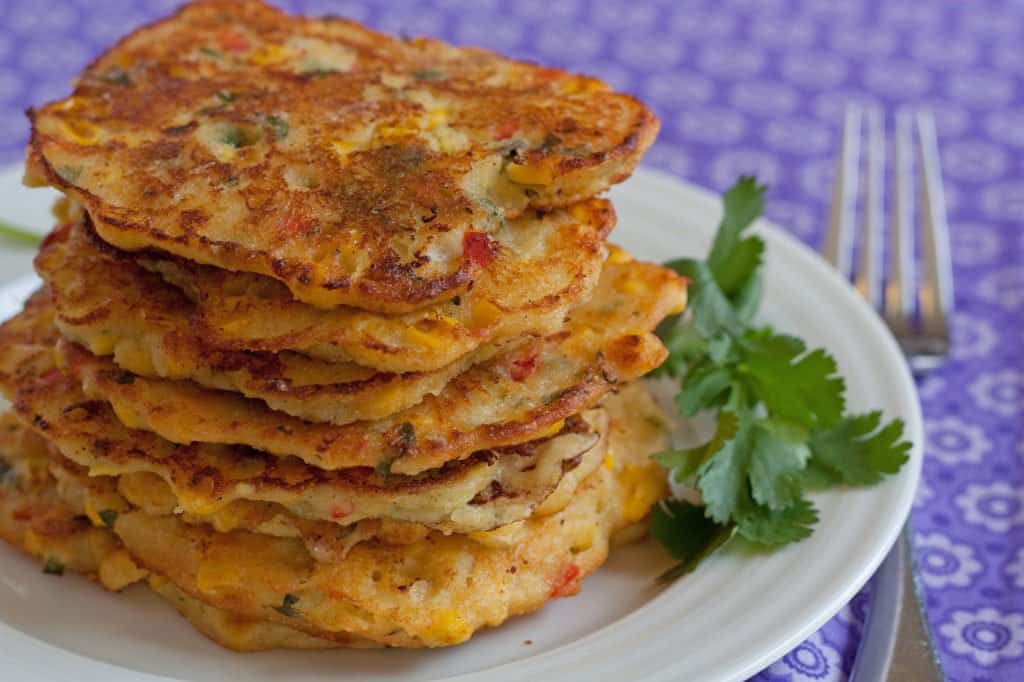 Spicy corn cakes stacked on a plate