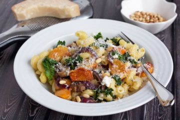 pasta with fuyu persimmons and goat cheese in a bowl