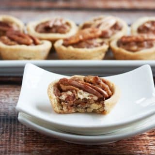 gluten free pecan tartlets one with a bite out of it
