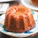 low angle, closeup shot of a mini honey cake on a blue and white plate.
