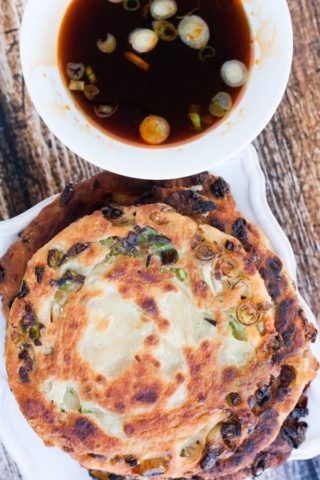 Scallion pancakes with a sauce on top.