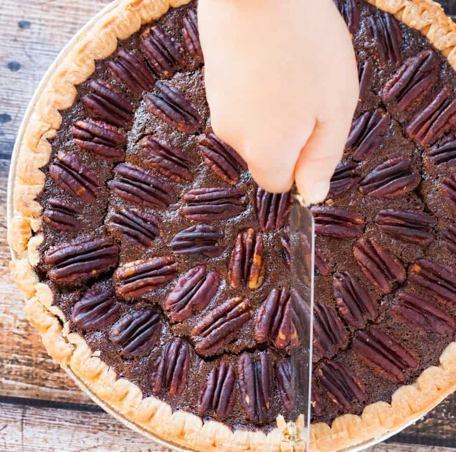 Chocolate pecan pie being sliced