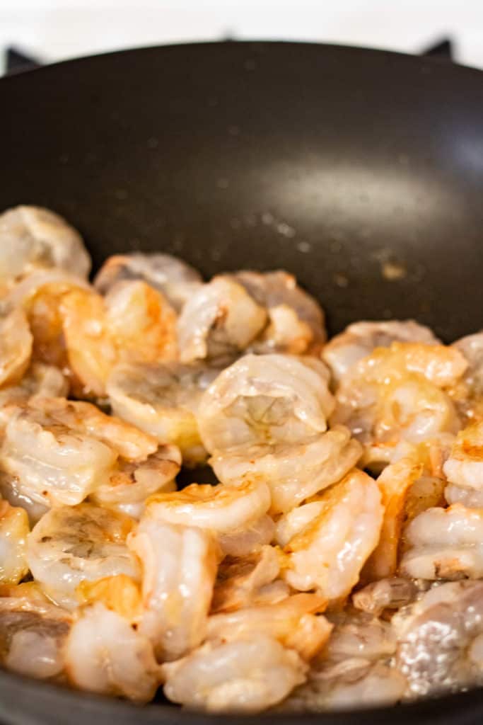 The shrimp cooking in a skillet.