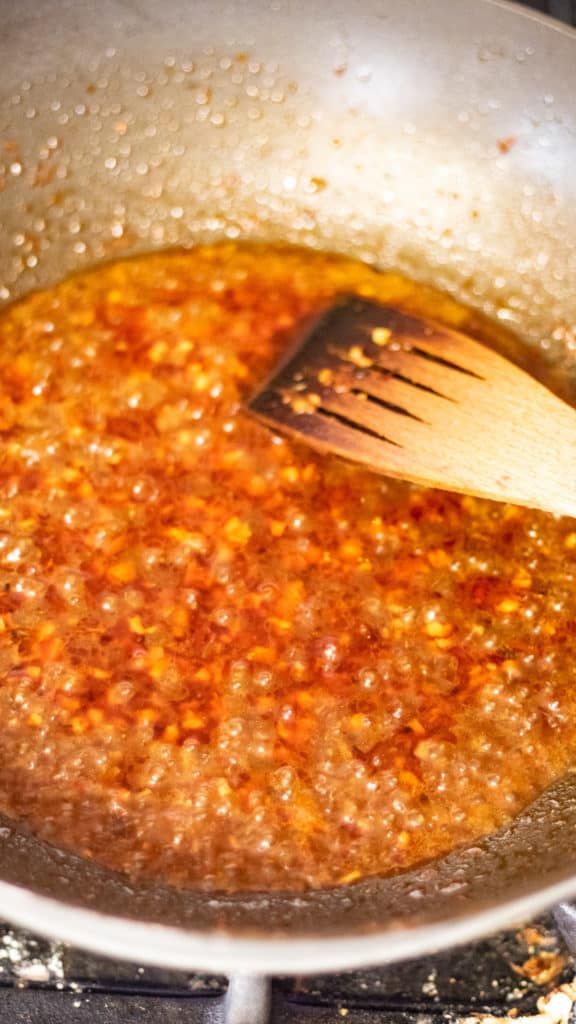 The sauce bubbling in a skillet.