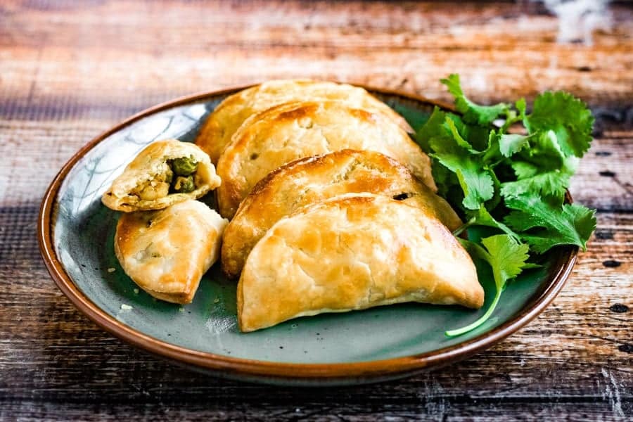 Thai curry puffs filled with ground chicken, potatoes, peas, onions, garlic and spices are a mouthwatering snack.