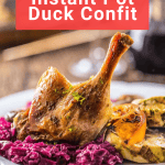 A plate of Instant Pot duck confit recipe served with braised red cabbage and roasted vegetables, with a recipe banner overhead.