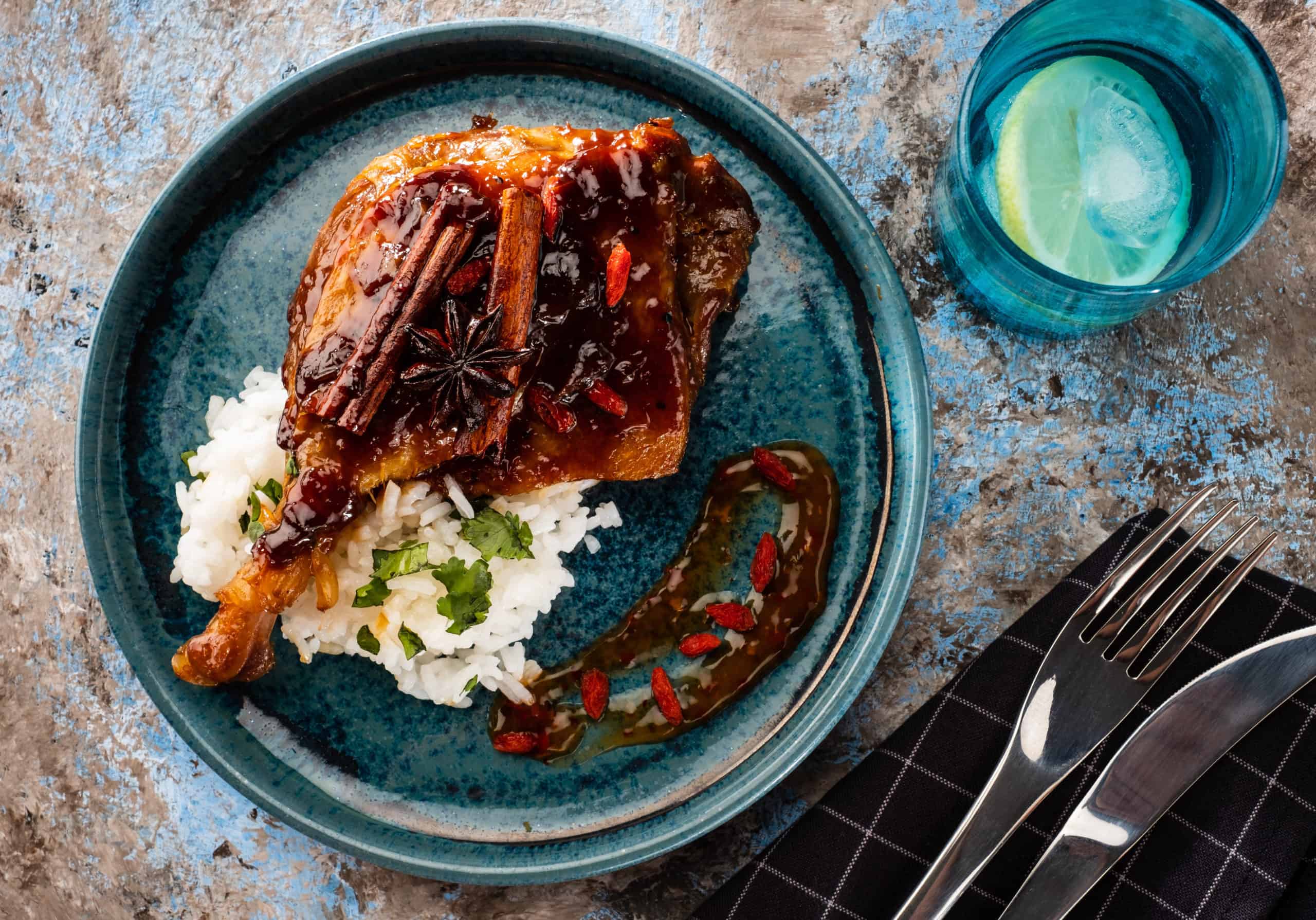 Overhead shot of instant pot duck confit, seared and topped with spiced pomegranate glaze