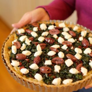 Savory tart with Greek olives, goat cheese, greens and an olive oil pastry crust
