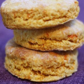 Three sweet potato biscuits stacked on top of each other.