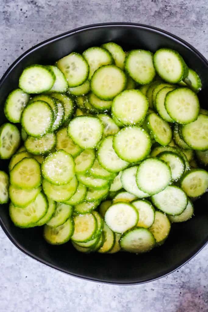 Sliced and salted cucumbers for Japanese cucumber salad.