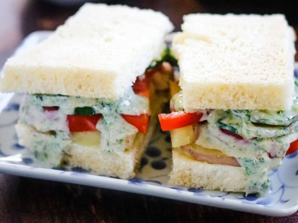 Bombay Sandwiches layered with potato, tomato, cucumbers, and an herb chutney sauce