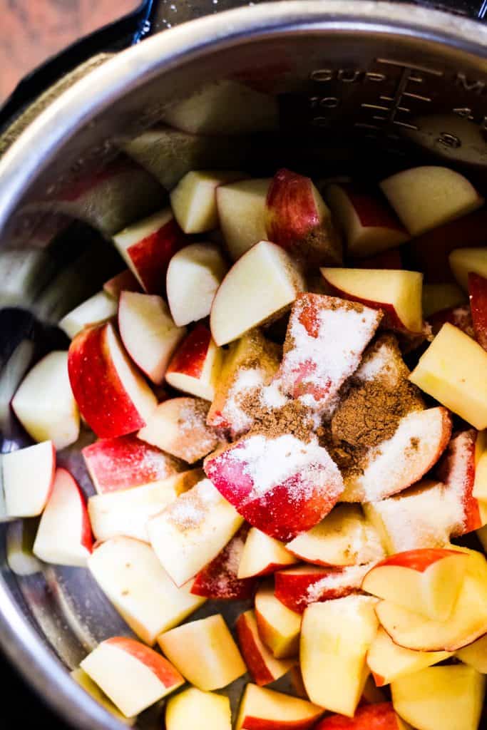 overhead shot of apples in the instant pot with sugar and cinnamon