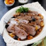 low angled shot of the brisket sliced on a platter.