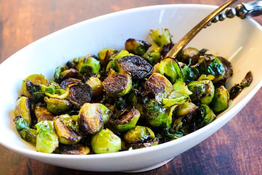 crispy brussels sprouts in a white serving bowl