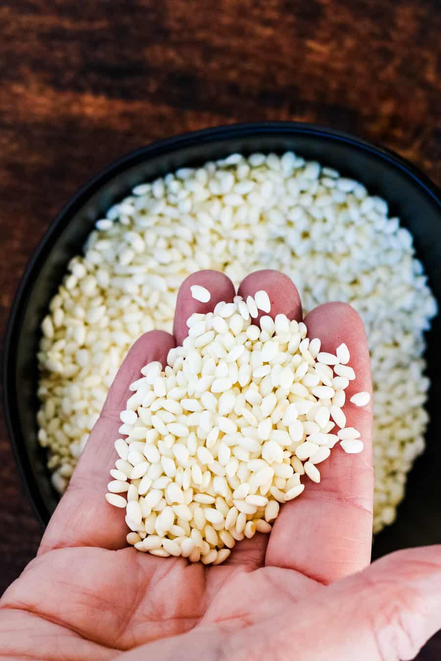 uncooked sticky rice in a hand
