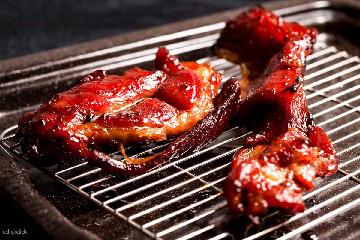 low angle shot of char siu on a grill.