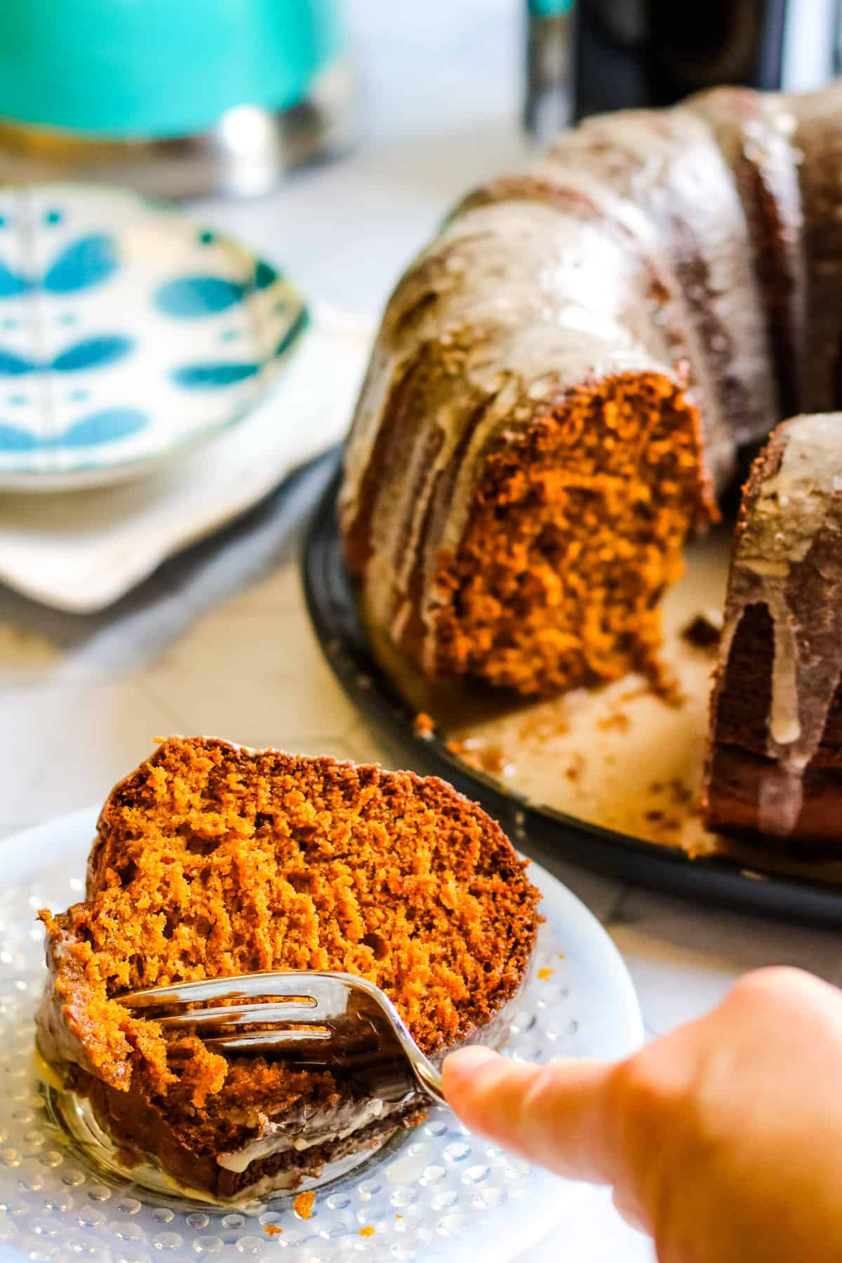 a fork cutting into a slice of pumpkin bundt cake