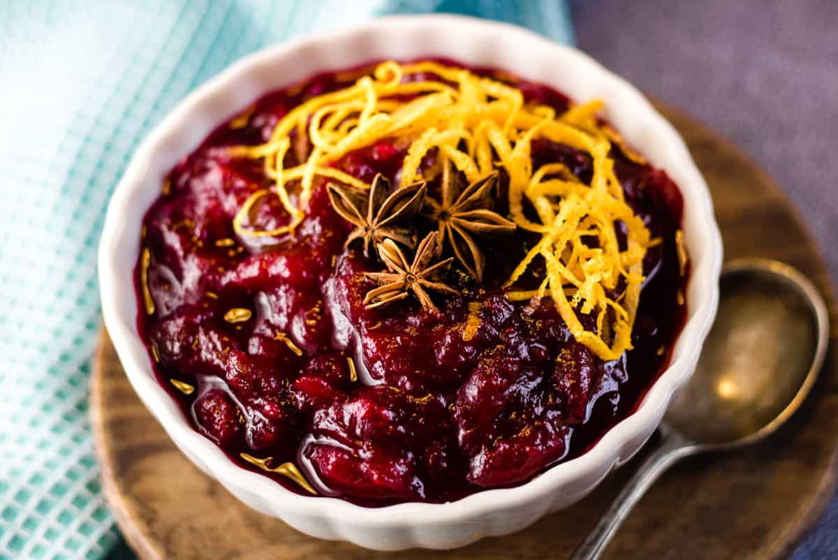 Cranberry sauce in a white bowl with orange zest.