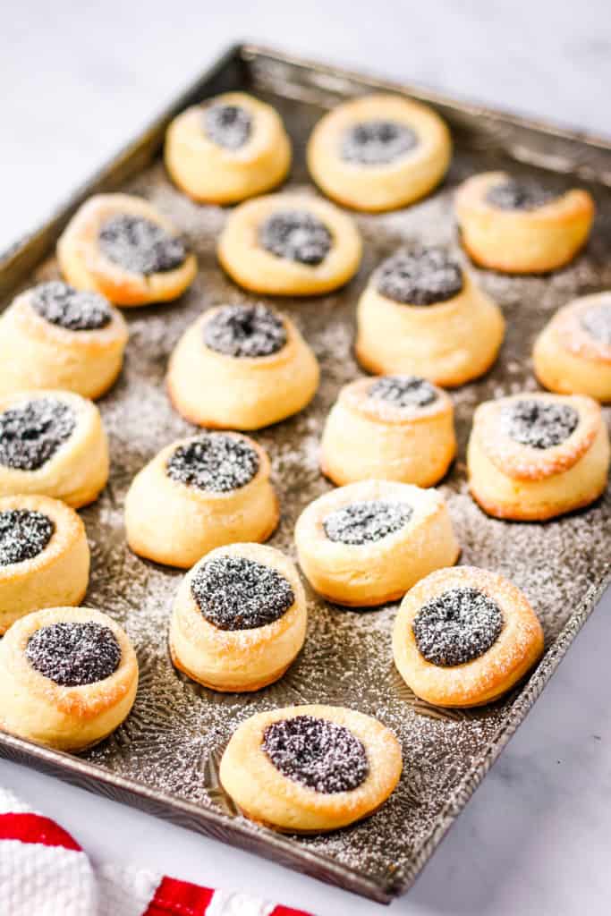 low angle shot of the pastries on a baking sheet with powdered sugar on top.