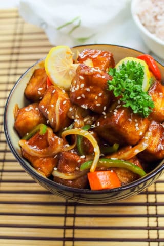 Low angle shot of vegetarian sweet and sour tofu in a bowl.