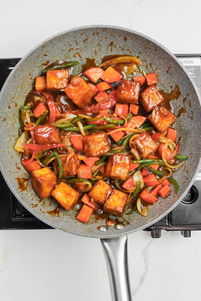 tofu and veg tossed in the sauce in the skillet.