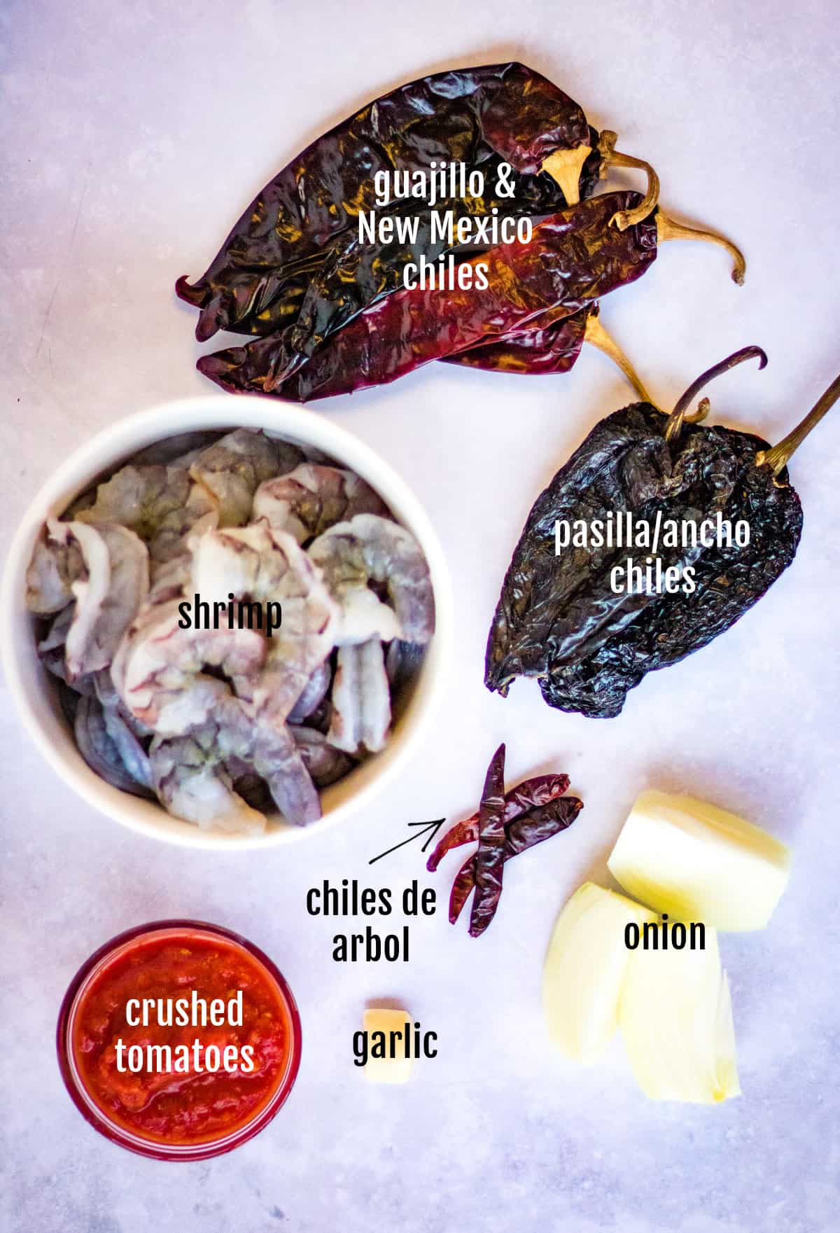 overhead shot of 4 different types of chiles: pasilla/ancho, new mexico, guajillo, and de arbol. These are the chiles used in this camarones a la diabla recipe.
