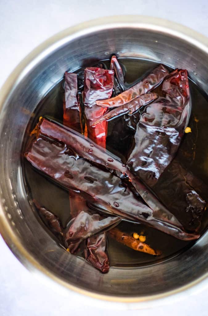 Dried chiles soaking in hot water.
