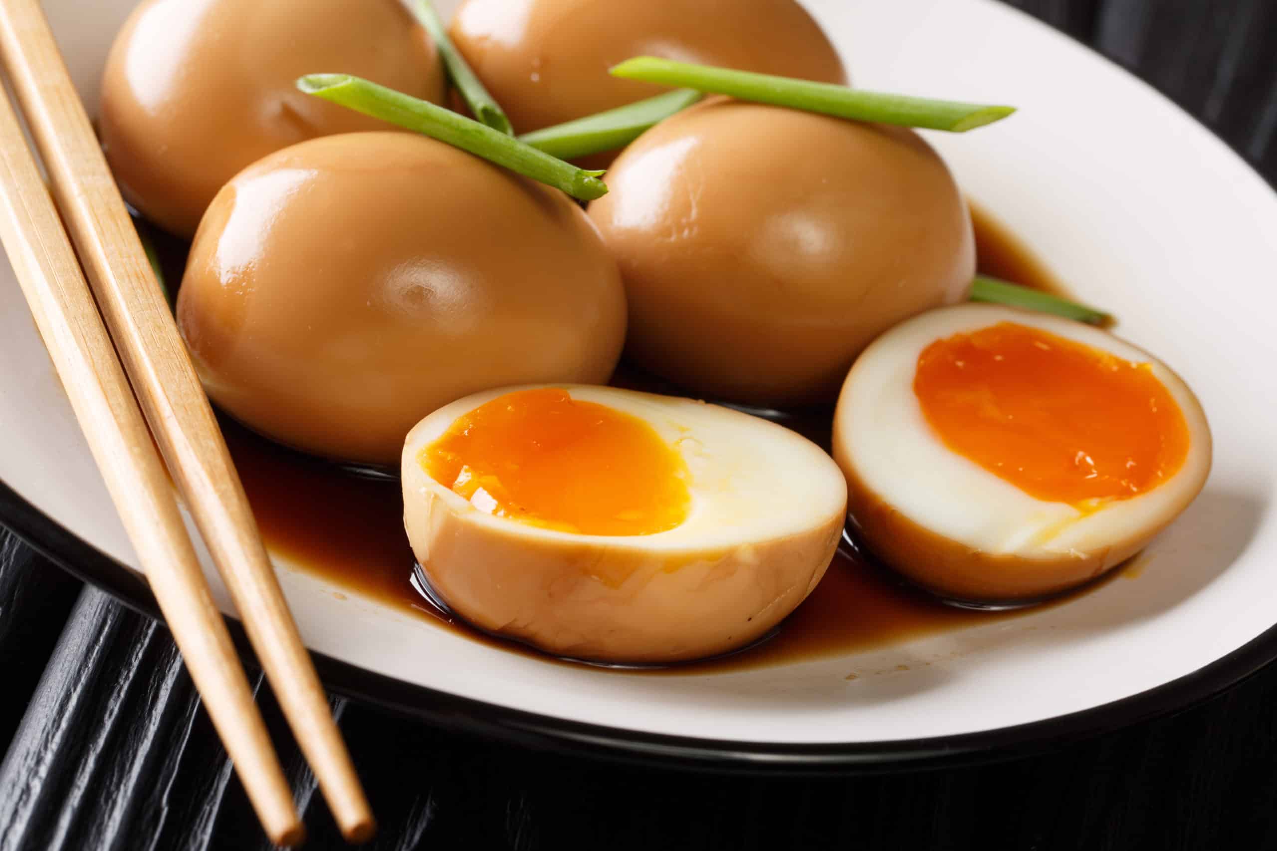 Soy sauce marinated eggs on a white plate.