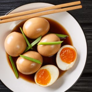 Overhead shot of soy sauce eggs on a plate.