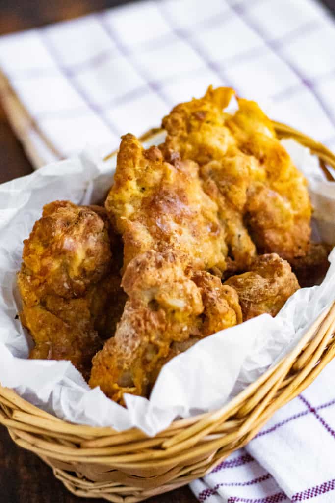Low angle shot of air fried chicken in a basket.