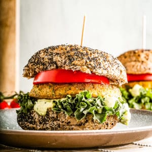 Low angle shot of a chickpea burger on seeded bun with all the fixings.