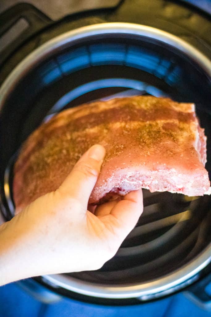 A person air frying instant pot spare ribs.