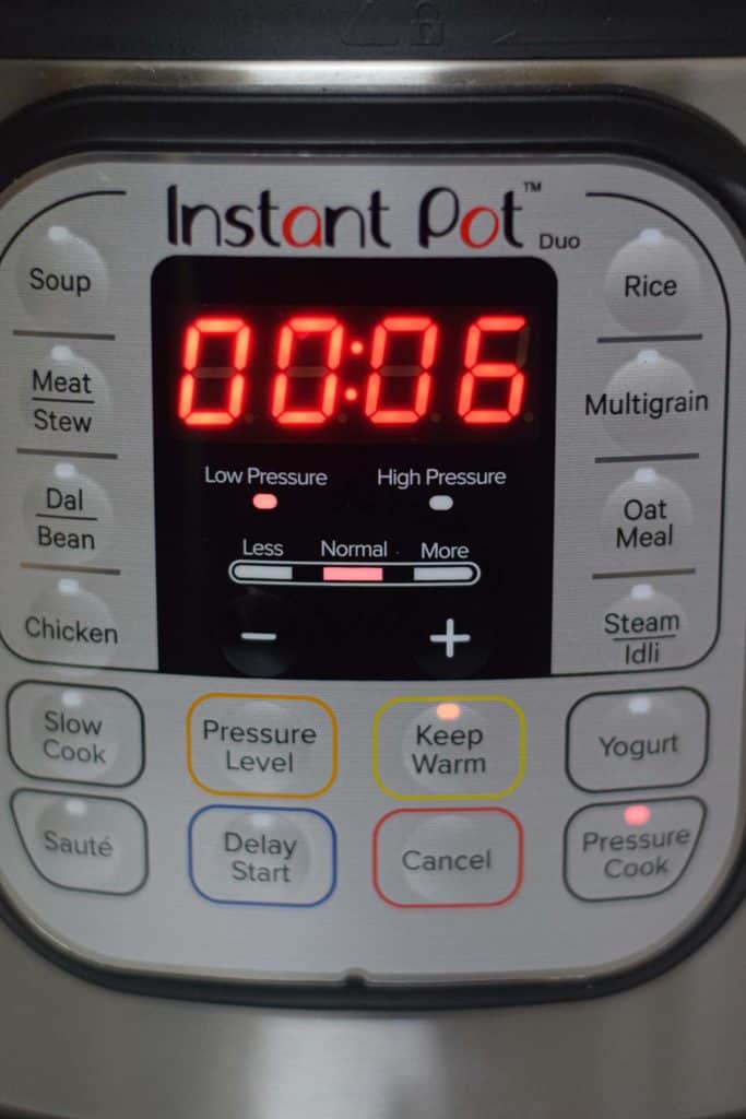 An instant pot with a visible timer for cooking biryani.