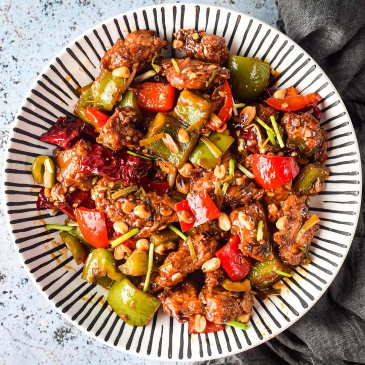 Overhead shot of Air Fryer Kung Pao Chicken in a black and white striped bowl