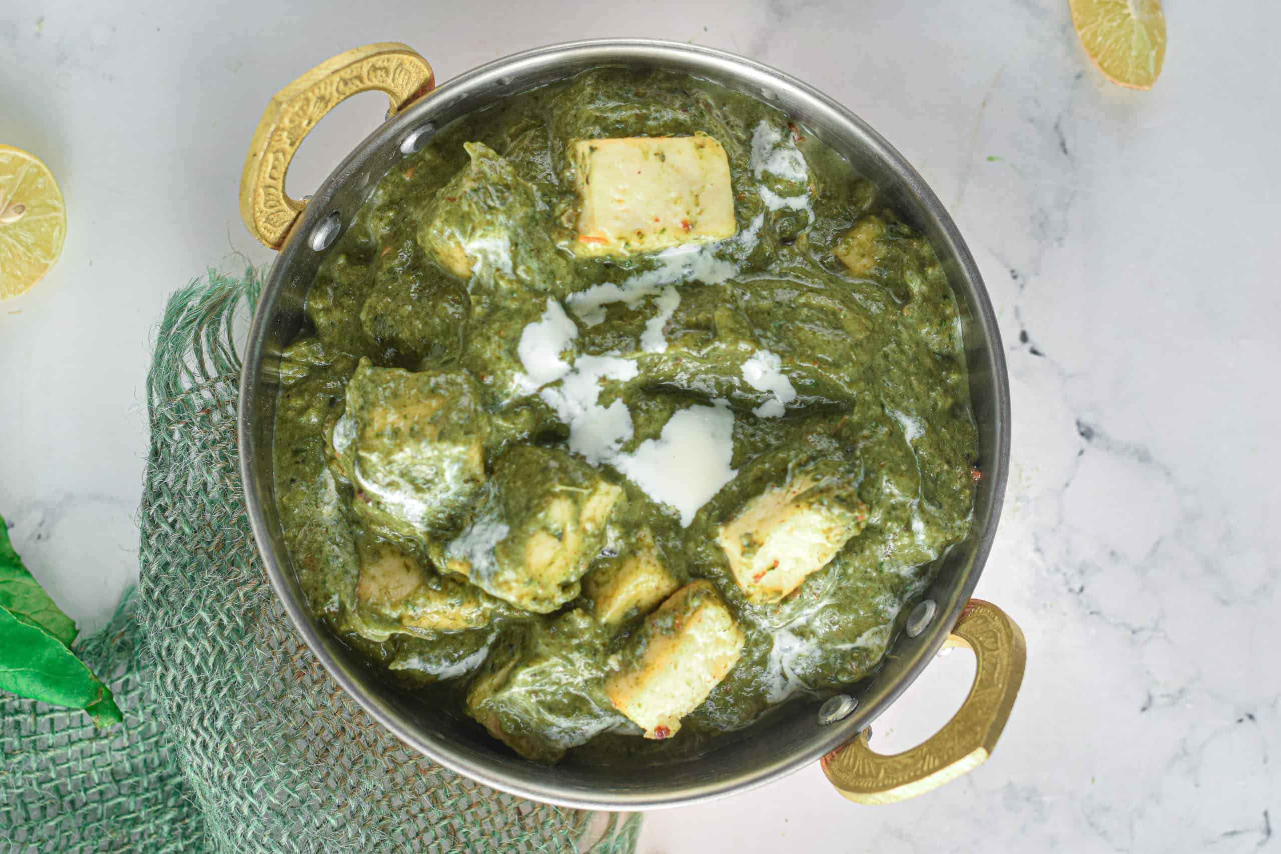 Overhead shot of a metal bowl filled with Instant Pot Palak Paneer