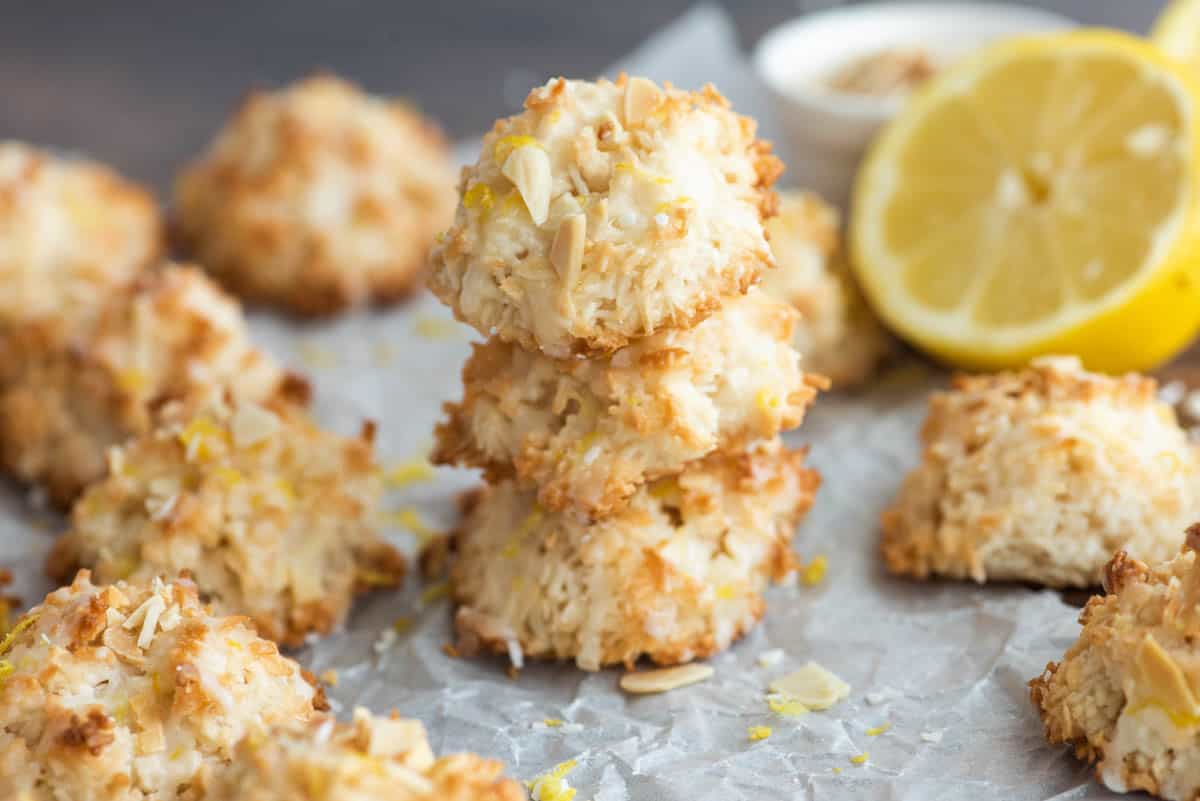 low angle shot of lemon coconut macaroons on a parchment paper lined baking sheet