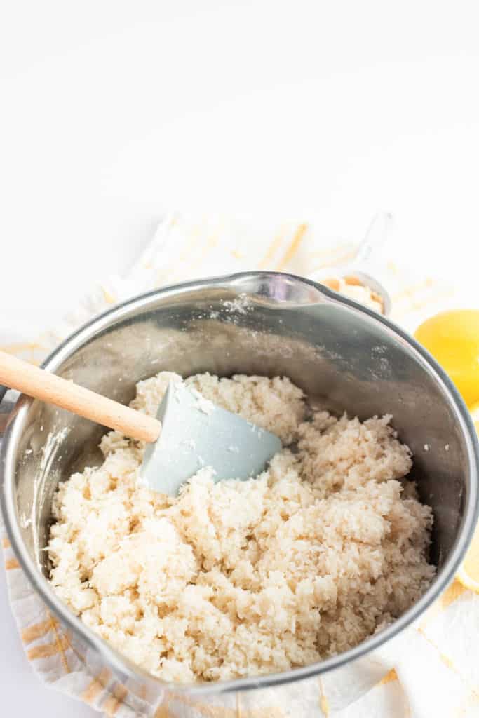 Lemon rice in a pan with coconut macaroons.