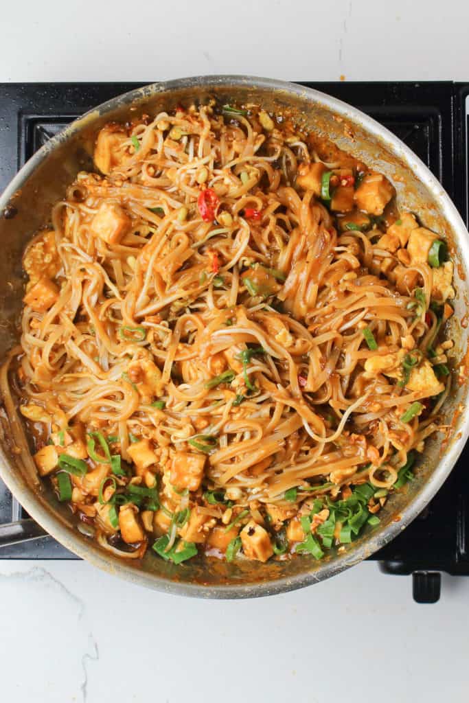 Keywords used: noodles, tofuDescription with modified keywords: A pan full of noodles and tofu cooking on a stove top.