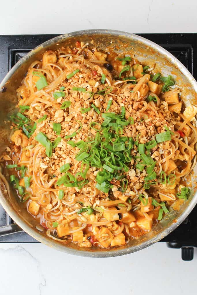 A stove-top dish of veggie pad thai with noodles and vegetables.