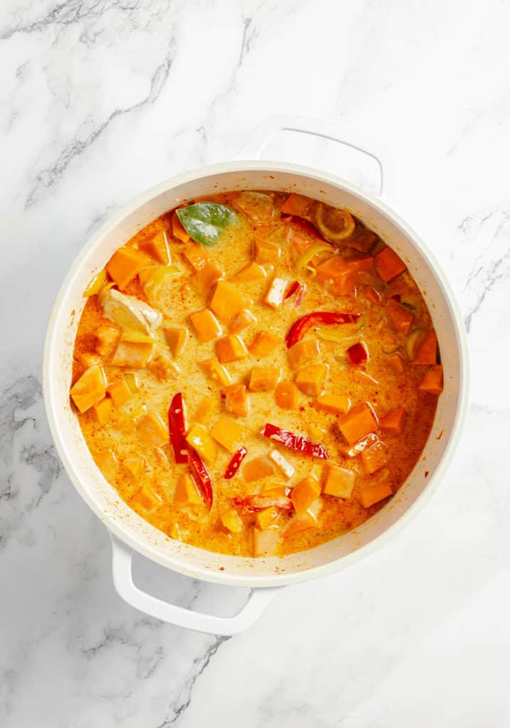 Thai sweet potato curry in a white pot with pumpkin.