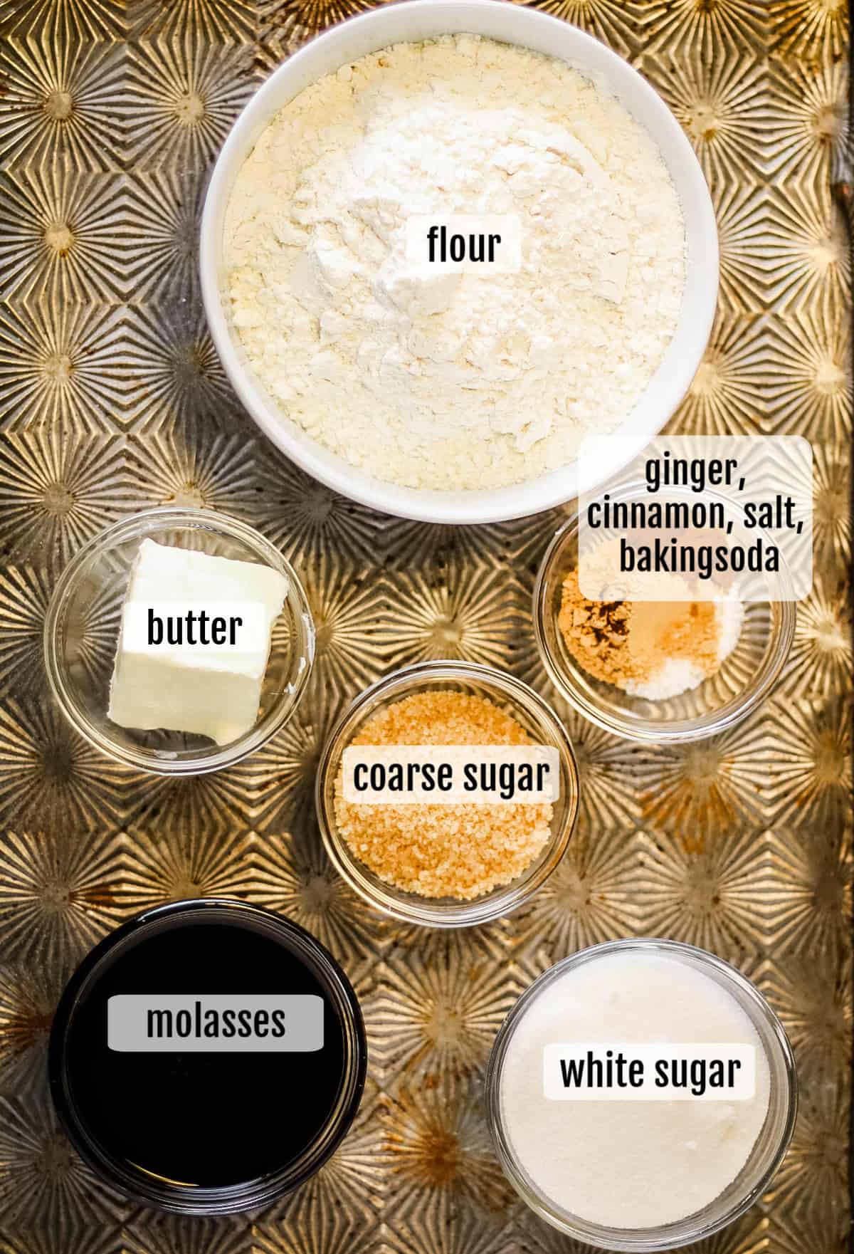 The ingredients for a delicious white cake, including ginger snap cookies, are displayed on a table.