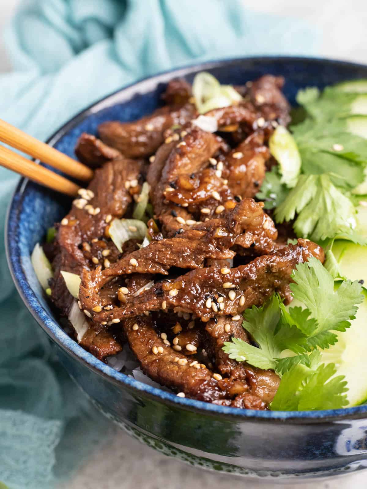 Bulgogi beef in a bowl with rice and cilantro.