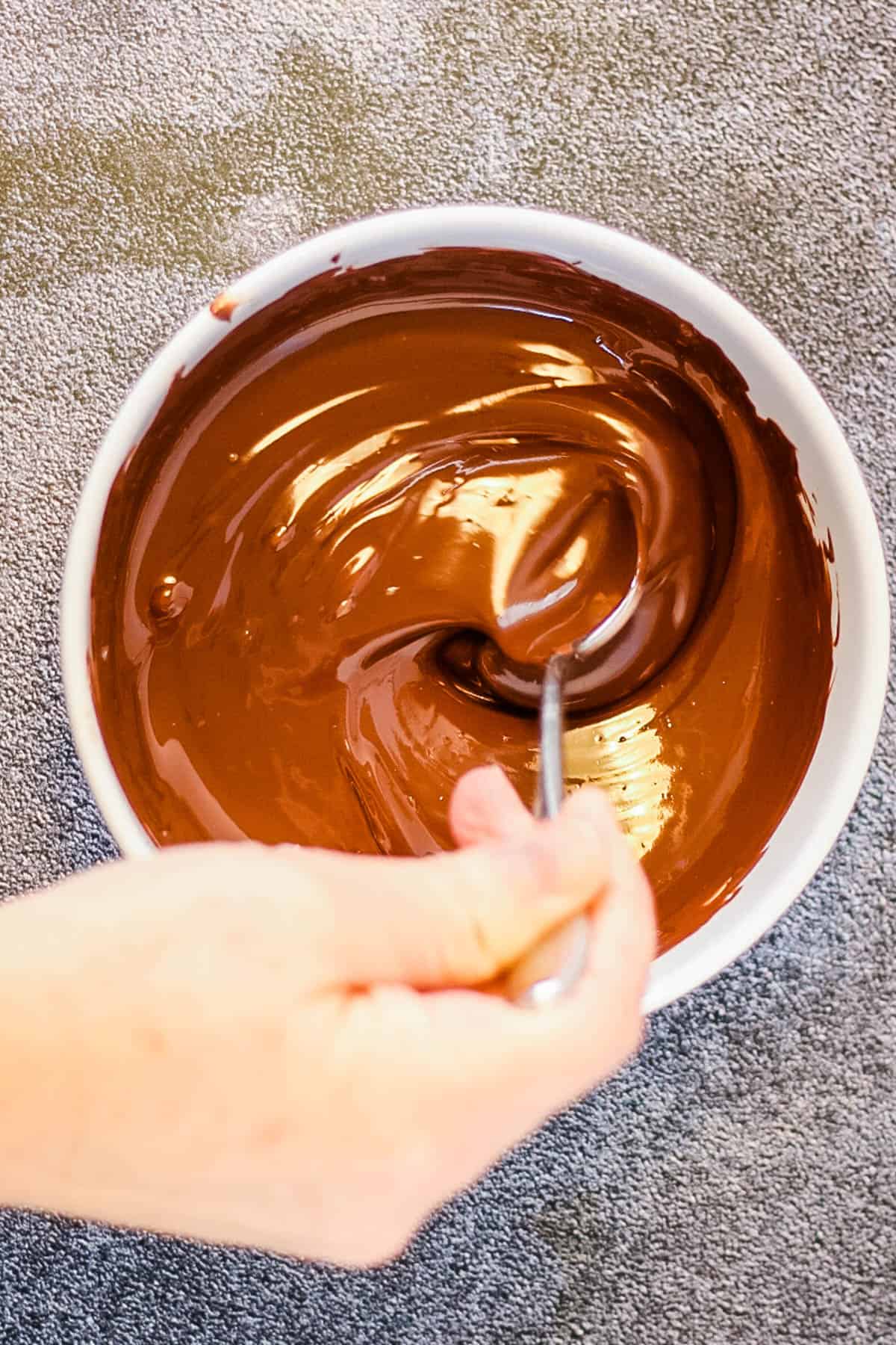 stirring the melted chocolate.