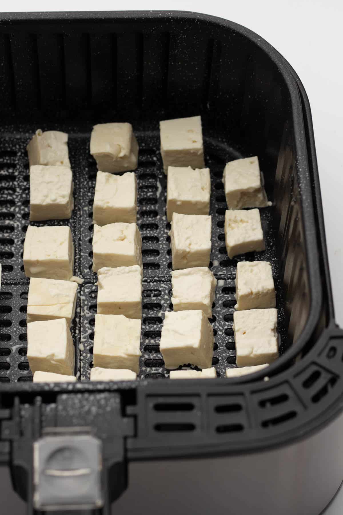 Tofu cubes cooked in an air fryer with salt and pepper.