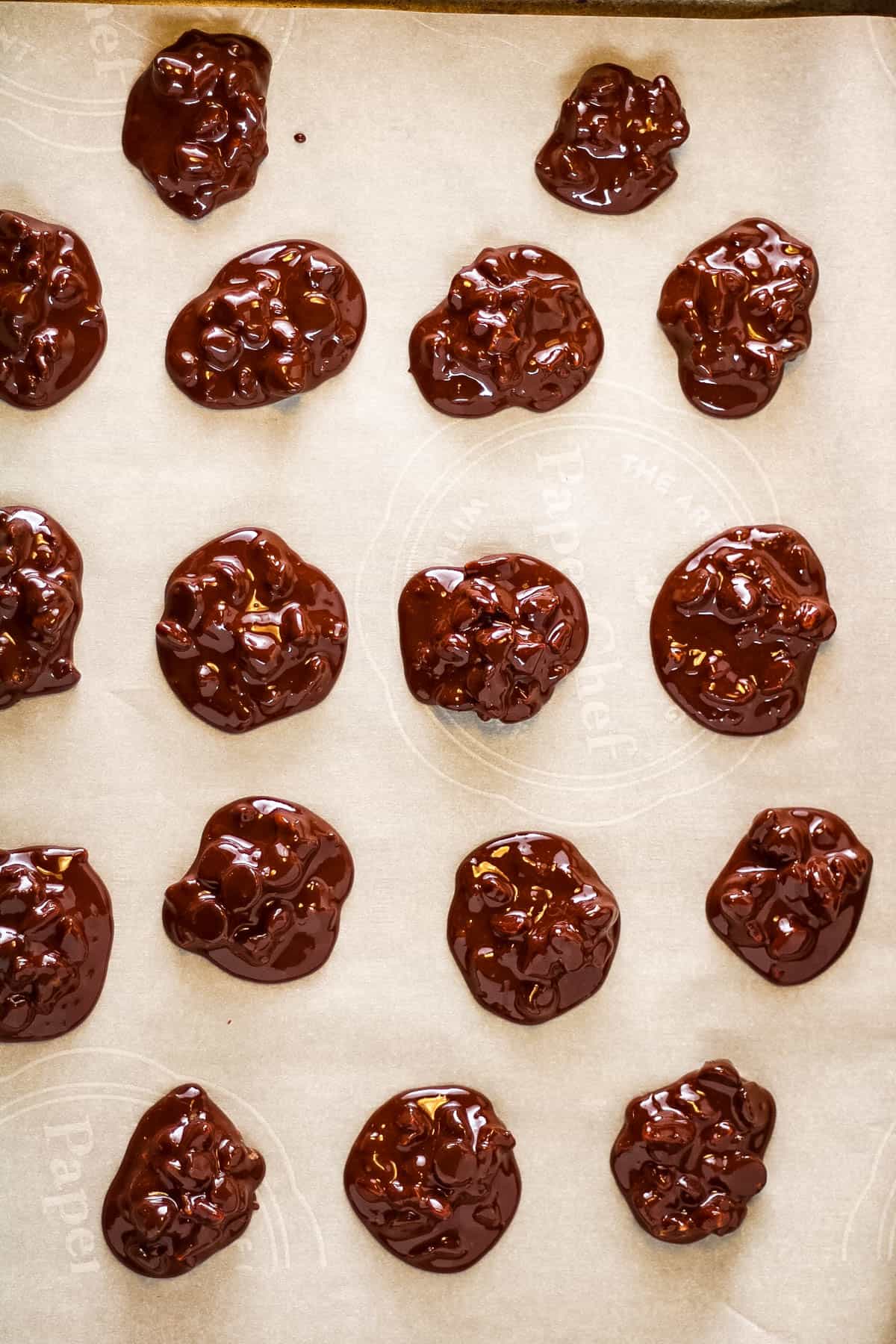 Flourless chocolate-covered cookies arranged on a baking sheet.