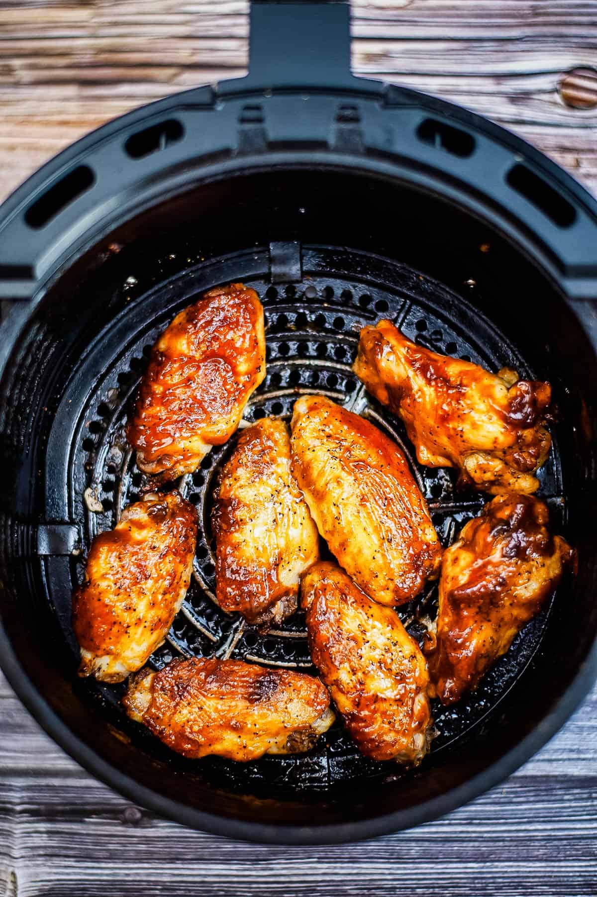 BBQ chicken wings in an air fryer basket